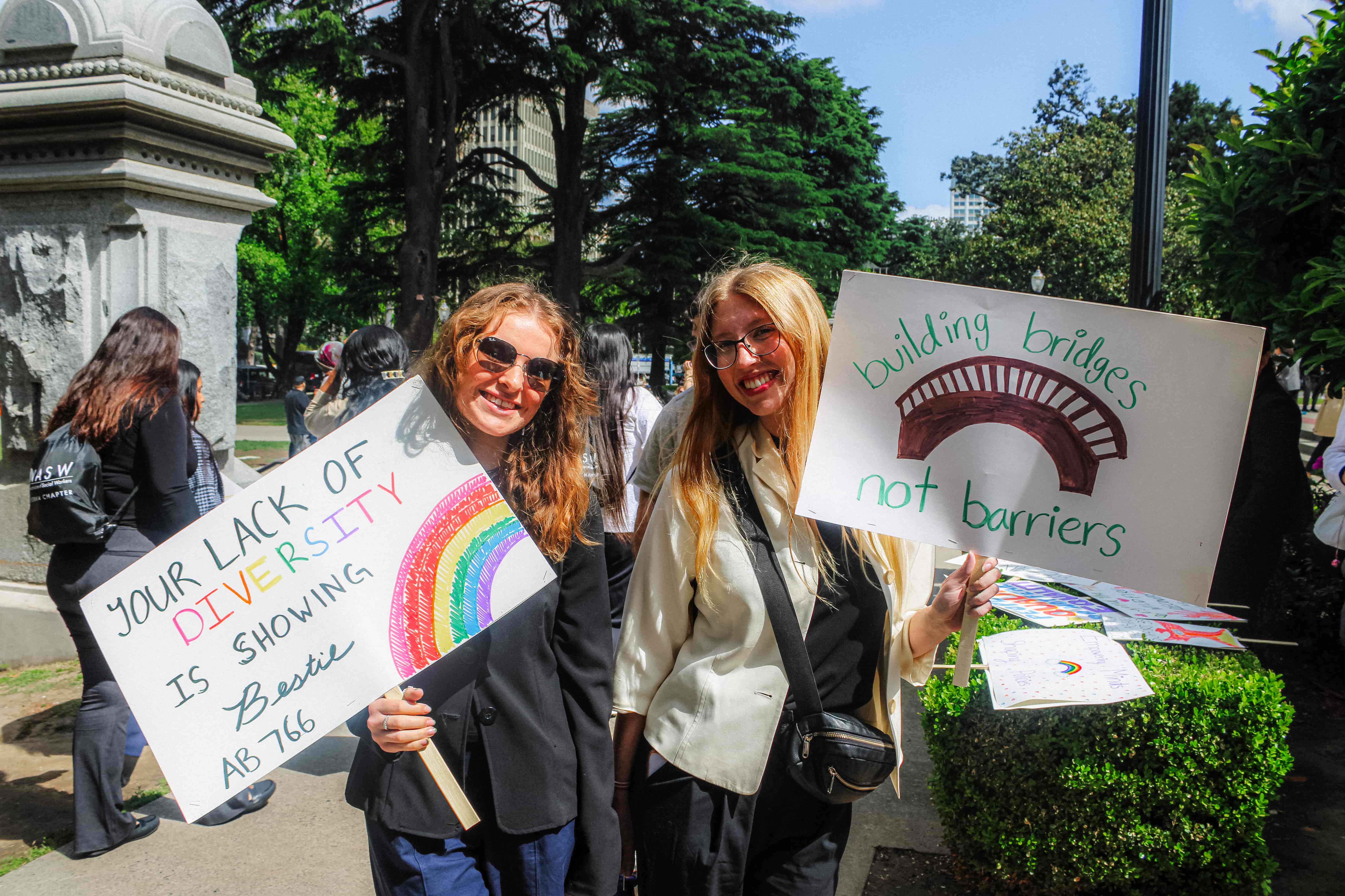 Two Students holding up posters at 2025 Lobby Days Rally