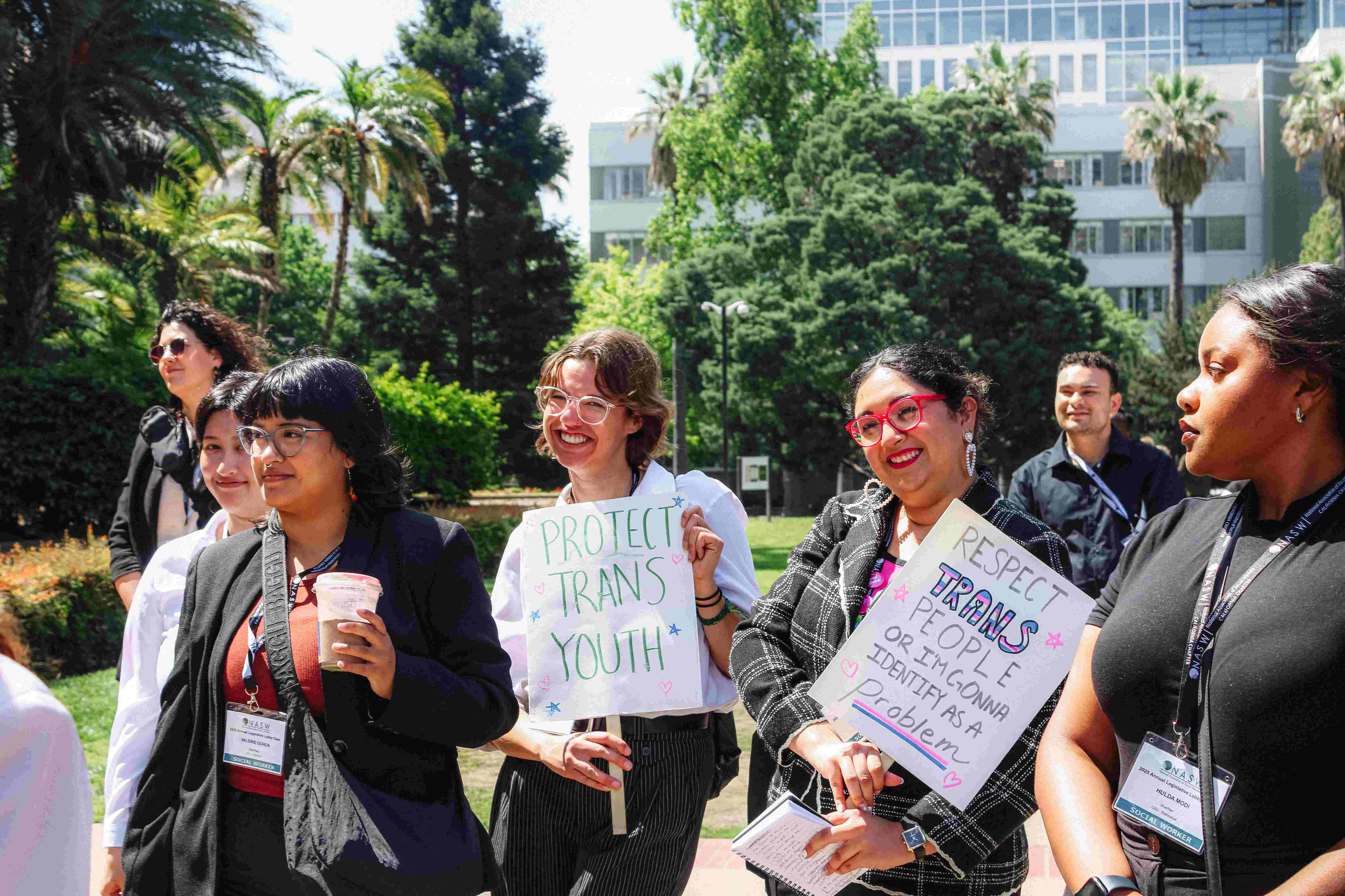 Two Students holding posters regarding transgender rights at 2025 Lobby Days